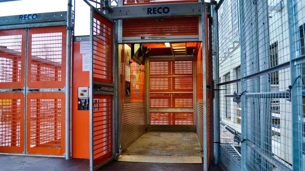 RECO Common Tower landing gates with Alimak passenger hoist at high-rise construction site
